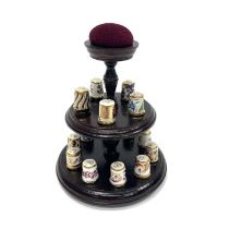 A collection of fifteen Royal Crown Derby thimbles on two tier turned wooden stand with pin