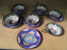 A set of six Persian enamelled tea cups and saucers (12)