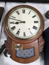 A mahogany cased drop dial wall clock, circular enamelled dial, brass bezel, above frosted glass