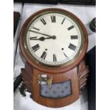 A mahogany cased drop dial wall clock, circular enamelled dial, brass bezel, above frosted glass