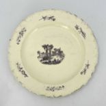 A large English creamware charger, 18th century, decorated with an image of Palmyra. 39 cm