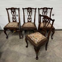 A set of four chippendale-style dining chairs, on cabriole and sabre supports