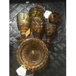 A collection of Bohemian amber glassware, including two sweetmeat jars and covers, a goblet with