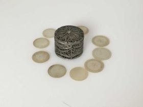 A silver-coloured metal filigree counter box, with ten decorated mother-of-pearl counters,