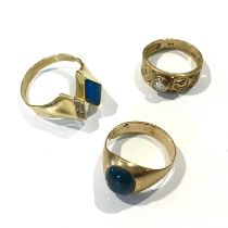 Three yellow metal gem-set rings