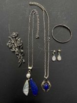 A collection of silver jewellery to include semiprecious stones and an interesting hinged floral