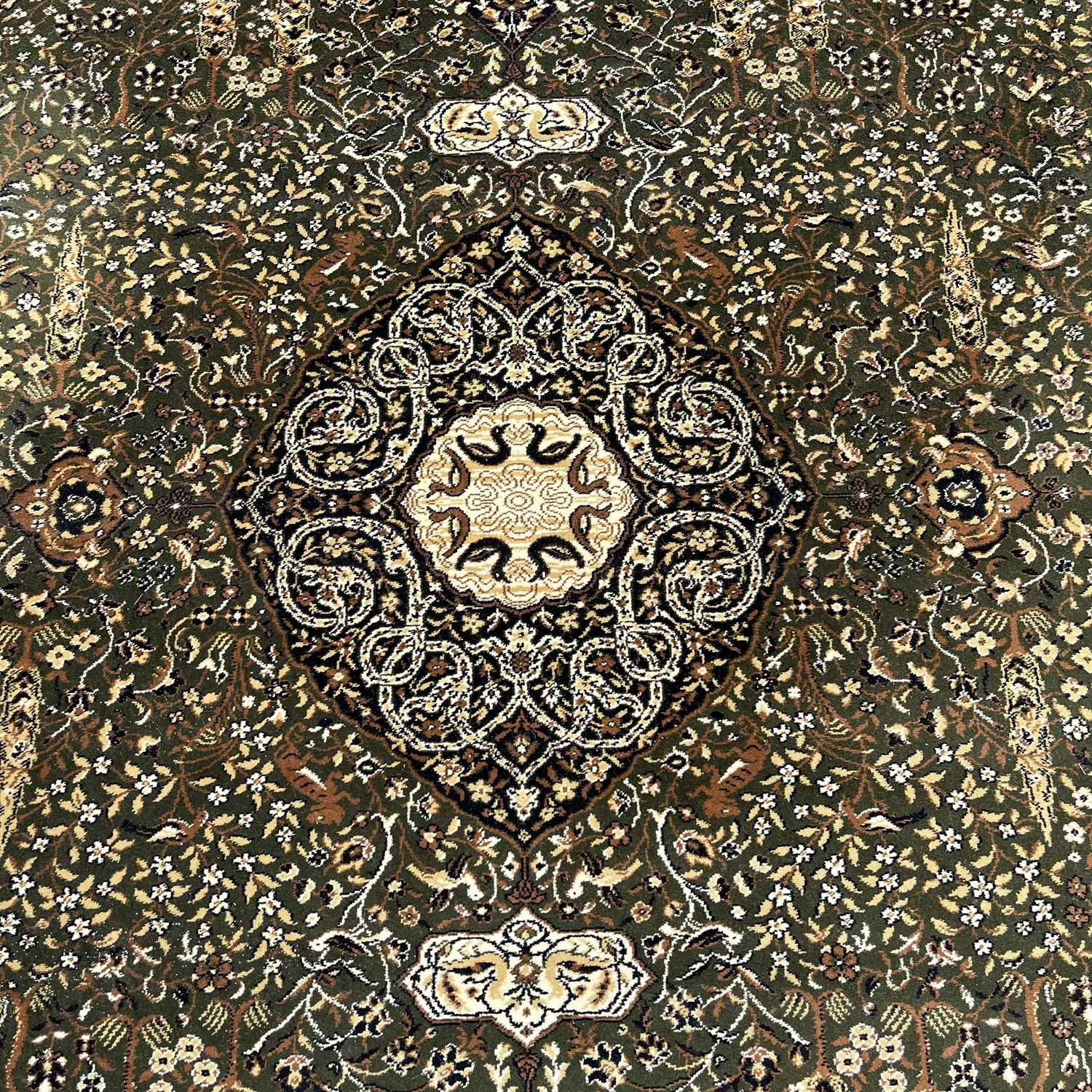 A large rug, muted green field with cream medallion and border designs, covered with floral and - Image 4 of 6