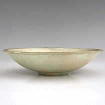 A Chinese celadon glazed dish, lobed everted rim, central incised ring, the exterior with tooled