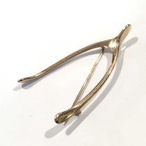 An early 20th century gold wishbone brooch