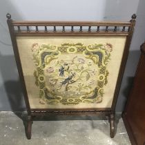 A late Victorian mahogany Aesthetic Movement firescreen, circa 1880, finials, ting turned spindle