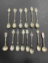 A collection of 14 continental and British silver spoons including 12 souvenir spoons from Bergen op