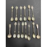 A collection of 14 continental and British silver spoons including 12 souvenir spoons from Bergen op