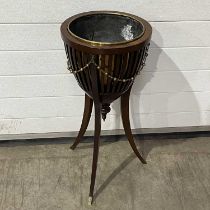 A regency style mahogany jardinière with brass liner , on three splayed supports W: 40 cm H: 73 cm