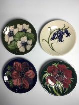 Four Moorcroft coasters, including Anemone Tribute by Emma Bossons circa 2002; Bluebell by Kerry