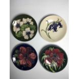 Four Moorcroft coasters, including Anemone Tribute by Emma Bossons circa 2002; Bluebell by Kerry