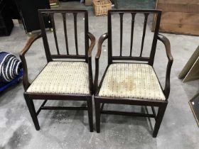 A pair of George III mahogany armchairs, circa 1810, of Hepplewhite design, bar splats, curved arms,