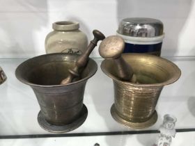 Two 19th century brass pestles and mortars, an Ung Sedative pottery drug jar, and associated metal