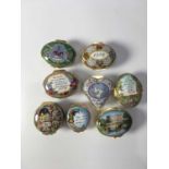 Eight Halcyon Days enamelled trinket boxes, including heart shaped box decoarted with doves and