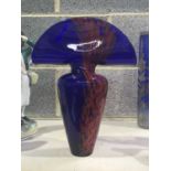 A Bohemian Szech Iris blue glass vase, hammer head and baluster form, with red marbled decoration,