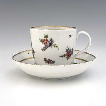 A Richard Champion Bristol porcelain cup and saucer, circa 1770, painted with central floral bouquet