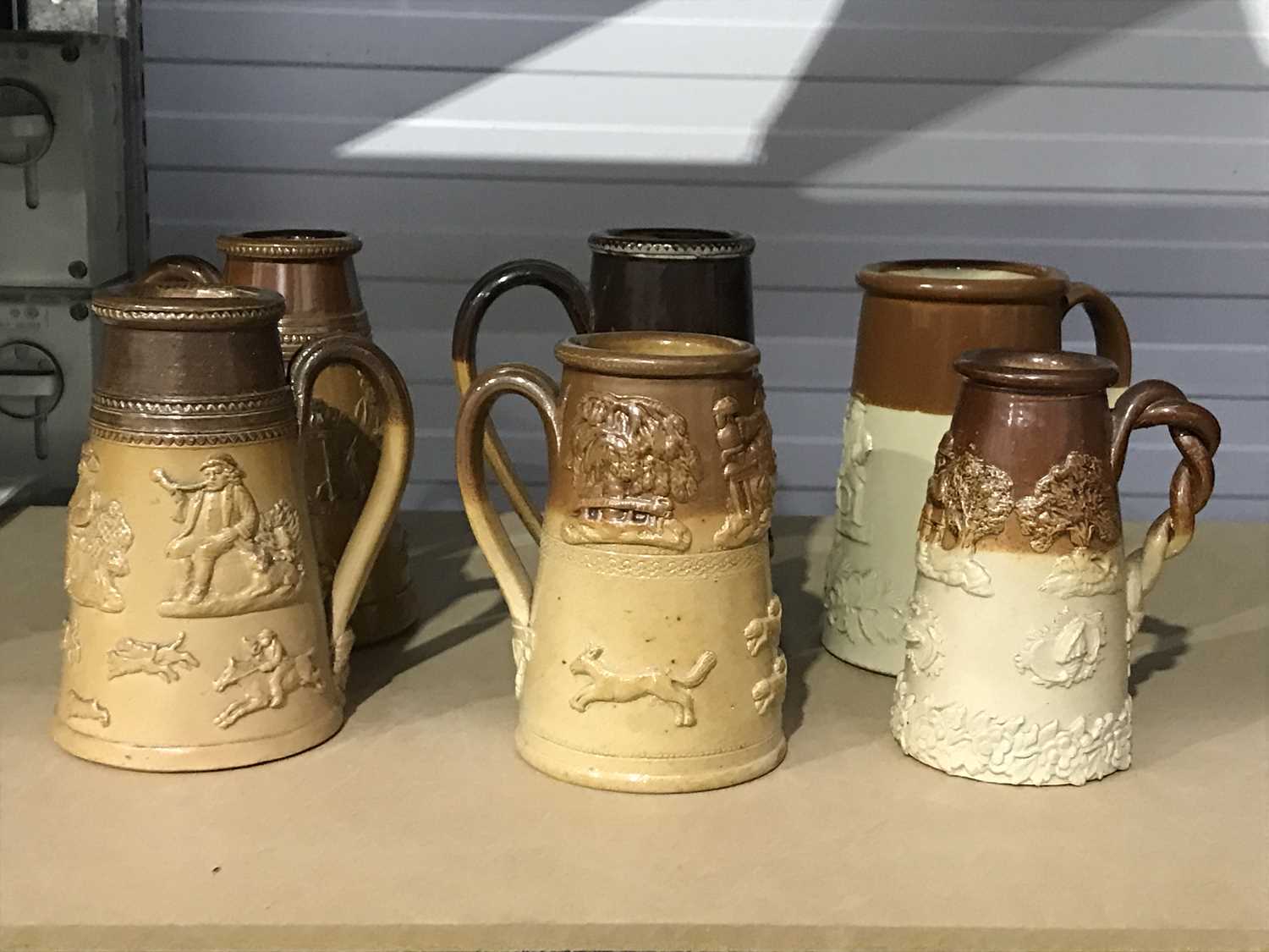 A collection of Stoneware saltglazed mugs, in the style of the Mortlake and Vauxhall factories,