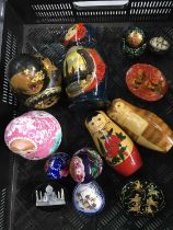 A collection of Matryoshka stacking dolls, two papier mache lidded boxes, a soapstone box and two