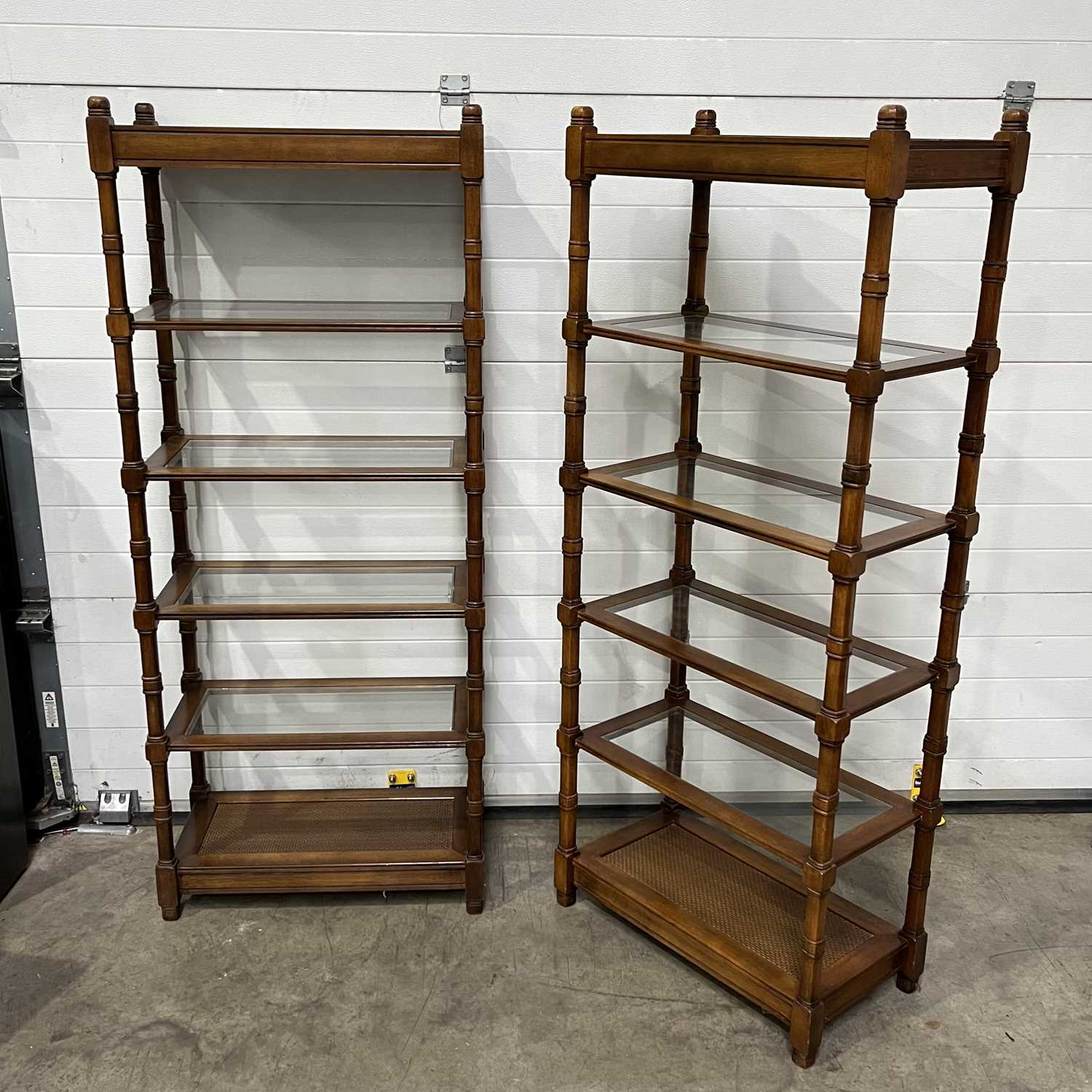 Two glass-shelved bookcases/display stands W: 76.5 cm D: 41 cm H: 183.5 cm