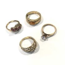 Four yellow metal gem-set rings