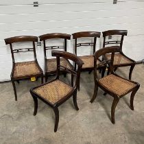 A set of six regency-style brass-inlaid dining chairs, with caned seats, on sabre supports (6)