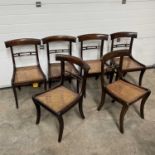 A set of six regency-style brass-inlaid dining chairs, with caned seats, on sabre supports (6)