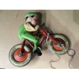 A Tri-ang Cord Gyro cyclist, tinplate and celluloid, 20cm wide