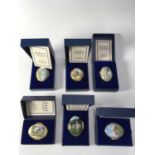 Six Halcyon Days enamelled Souvenir trinket boxes, oval and circular form, deocrated with historic