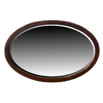 An oval wall mirror, with a bevelled edge W: 91 cm H: 62 cm
