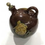 Noke for Royal Doulton, a Kingsware Fisherman flask, globe form with loop handle, brown glazed