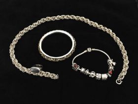 A selection of silver jewellery, including a heavy ropetwist necklace, a bangle with linked inset