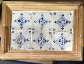 A set of six 18th/19th century Delft tiles, blue and white painted with flowers, 39 by 26cm, framed,