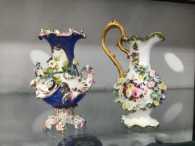 A Minton florally encrusted jug 17cm high, and a similar twin handled vase, 14cm high (2)
