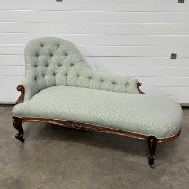 A Victorian style chaise longue, arched three quarter back, scrolling terminals, sabre and