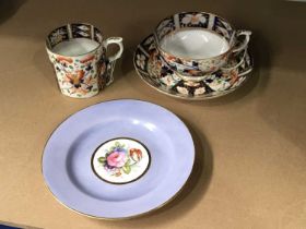 A Derby porcelain trio, two cups and saucer, mid 19th century, imari pattern, together with a floral