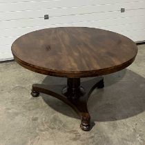 A large mahogany circular tilt-top table, on tripod supports, with carved feet W:130 cm H: 73 cm
