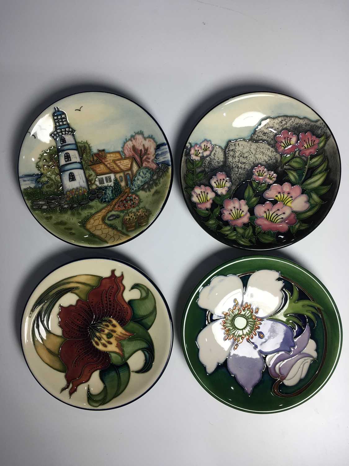 Four Moorcroft coasters, to include Anna Lily by Nicola Slaney, Moorcroft Collector's Club