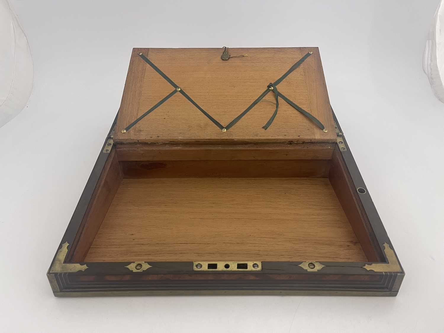 A George III flame mahogany campaign writing slope, circa 1820, brass-bound with a triple strung - Image 8 of 8