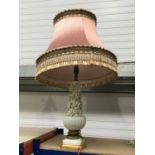 A white glazed French style lamp base, baluster form, the upper section with floral encrustations,