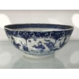 A Chinese blue and white bowl, footed form, painted with panels of boys within foliate border,