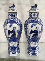 A pair of Chinese blue and white hexagonal section baluster vases and covers, four character