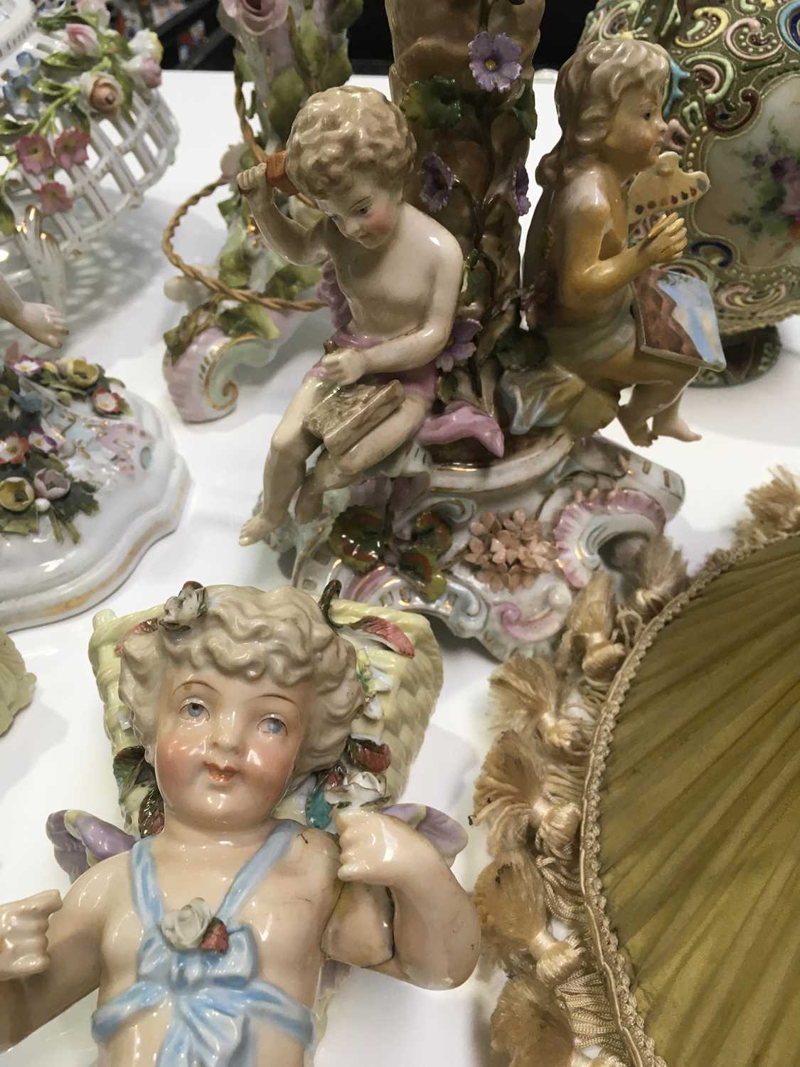 A pair of Conta & Boehme porcelain wall pockets, modelled as putti with grape baskets, together with - Image 2 of 3