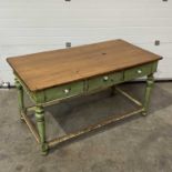 A rustic kitchen table, fitted with three frieze drawers, on turned and block supports, distressed