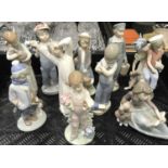 A collection of ten Lladro figures, including A Lesson Shared, Caribbean Kiss, Dutch Boy with Milk