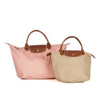 Longchamp, two Le Pliage handbags, to include a medium-sized pink example and a small beige example,