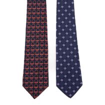Two silk designer ties, to include a blue camellia patterned tie by Chanel, and a navy blue tie by